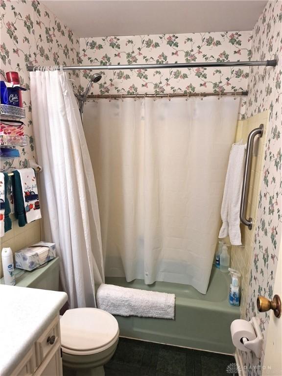 full bathroom featuring vanity, toilet, shower / tub combo, and tile patterned flooring