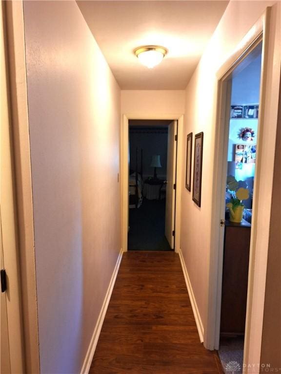 hallway with dark hardwood / wood-style floors