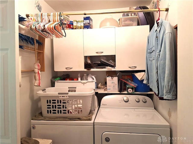 washroom with washing machine and dryer and cabinets