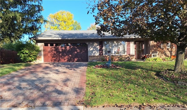 ranch-style home with a front yard and a garage