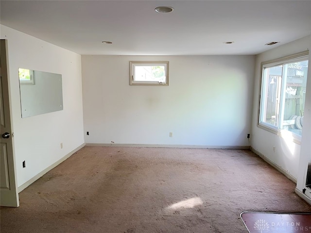 carpeted empty room featuring plenty of natural light