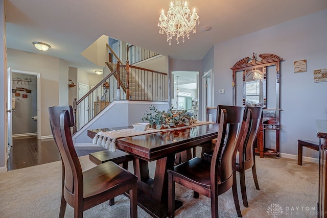 dining space with carpet flooring and an inviting chandelier