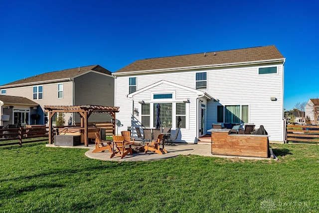 back of house featuring a pergola, a lawn, and a patio area