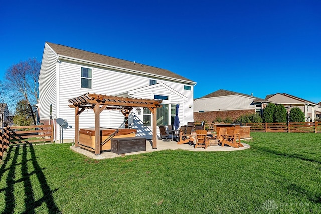 back of property with a hot tub, a pergola, a patio, a lawn, and an outdoor fire pit