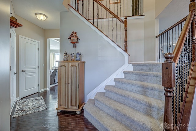 staircase with hardwood / wood-style floors