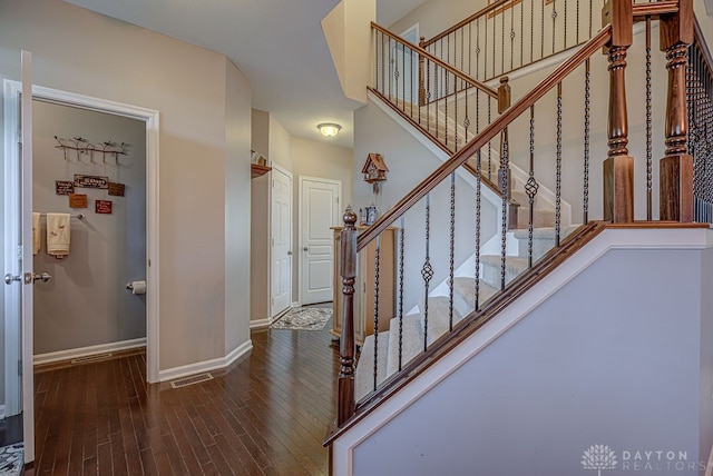 staircase with hardwood / wood-style flooring