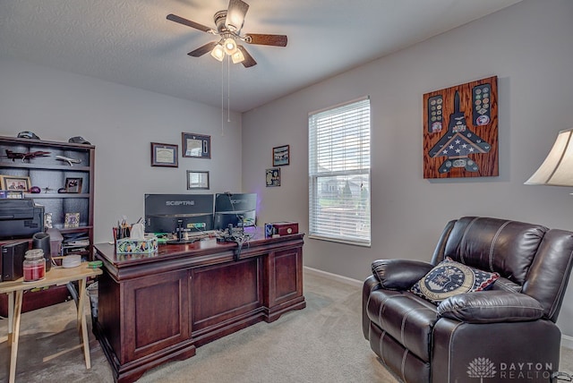 carpeted office with ceiling fan and a textured ceiling