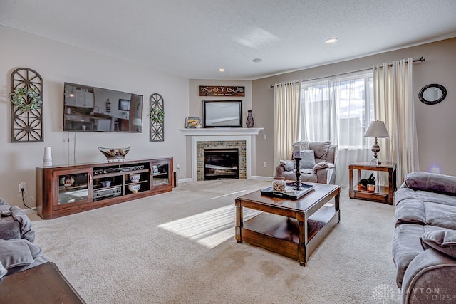 carpeted living room with a fireplace and a textured ceiling