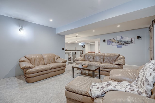 living room with a barn door and carpet