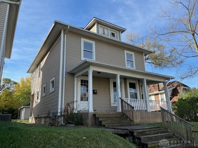 view of front of home with covered porch and a front yard