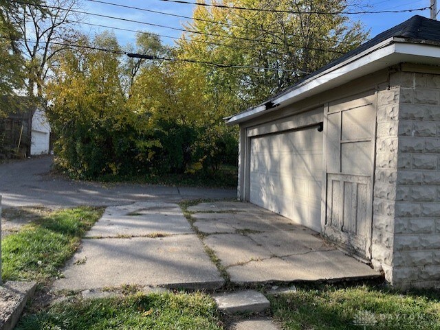 view of side of property featuring an outbuilding and a garage