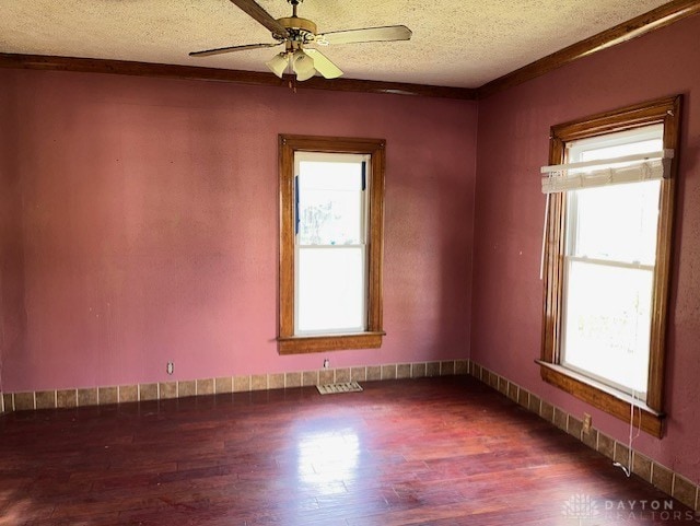 spare room featuring ceiling fan, hardwood / wood-style flooring, and a textured ceiling