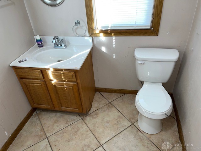 bathroom with vanity, toilet, and tile patterned floors