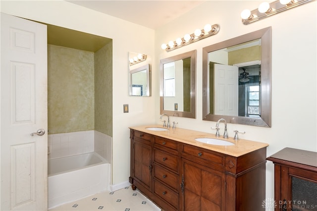 bathroom with a bathing tub, vanity, plenty of natural light, and ceiling fan