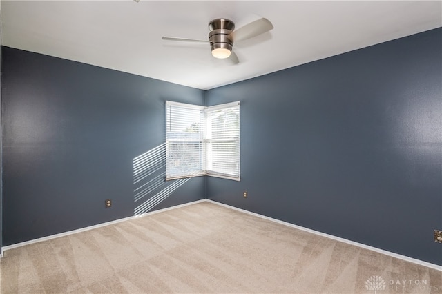 spare room with carpet floors and ceiling fan