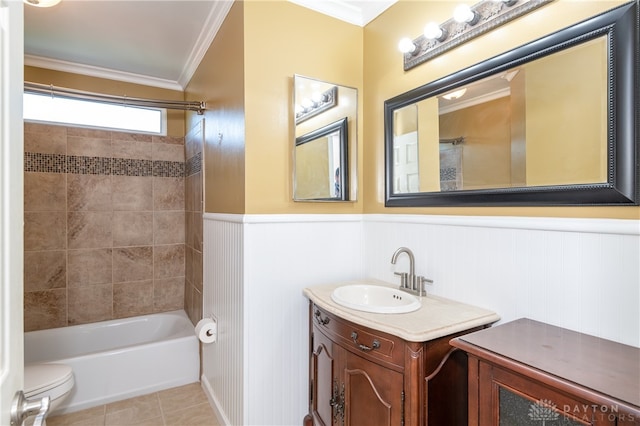 full bathroom featuring tiled shower / bath, toilet, vanity, crown molding, and tile patterned floors