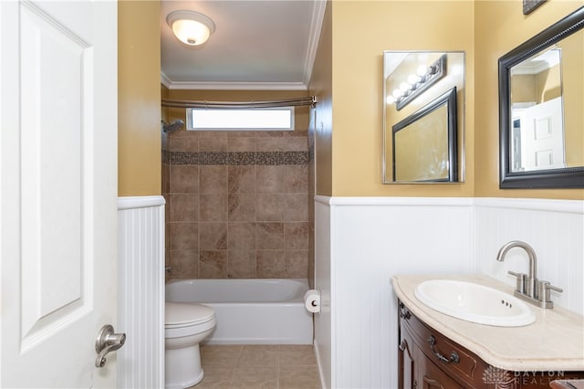 full bathroom featuring toilet, ornamental molding, vanity, tiled shower / bath combo, and tile patterned floors