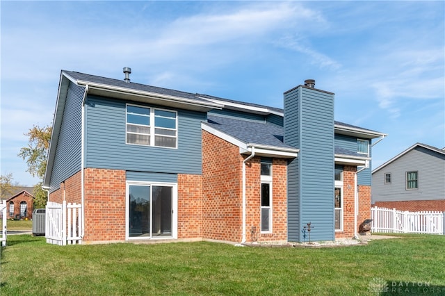 back of property featuring cooling unit and a lawn