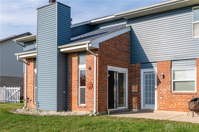 back of house featuring a patio area and a yard