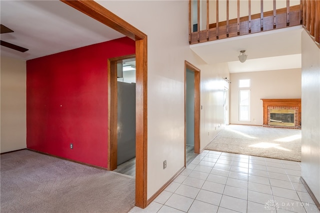 hall with light colored carpet