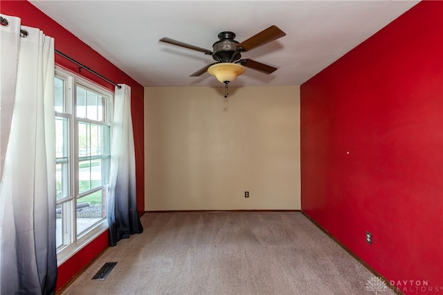 carpeted spare room with ceiling fan