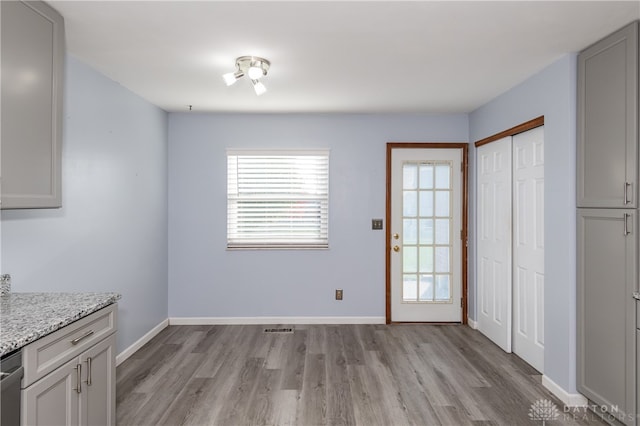 unfurnished dining area with light wood-type flooring