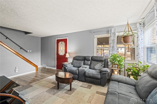 living room with a textured ceiling and hardwood / wood-style flooring