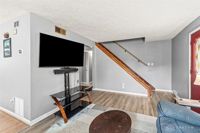 living room featuring hardwood / wood-style floors and a textured ceiling