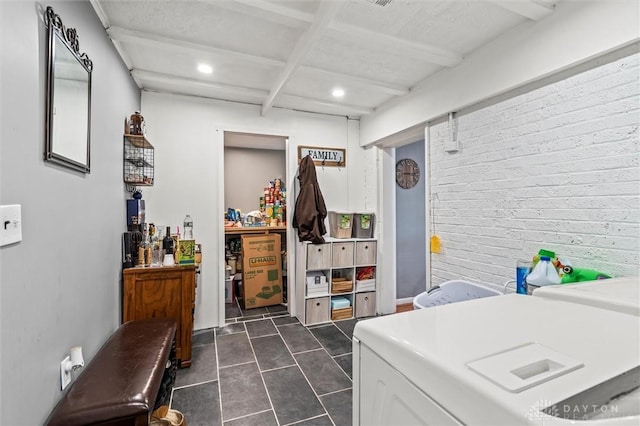 clothes washing area with washing machine and dryer