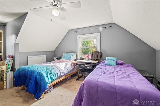 bedroom with carpet, radiator, vaulted ceiling, ceiling fan, and a textured ceiling