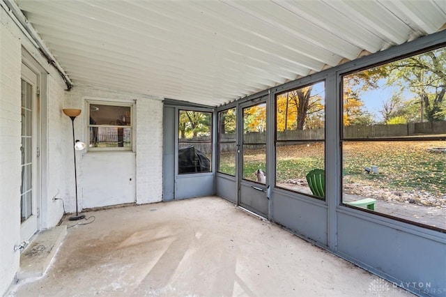 unfurnished sunroom with vaulted ceiling