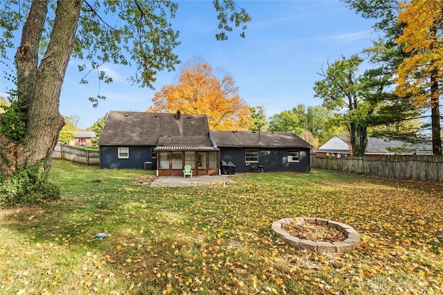 rear view of property featuring a lawn and a patio area