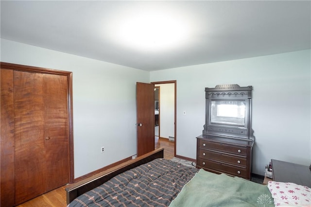 bedroom featuring light hardwood / wood-style floors and a closet