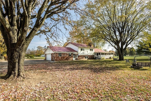 view of yard with a sunroom and a garage