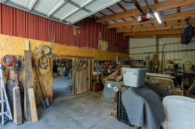 garage with a workshop area and a garage door opener