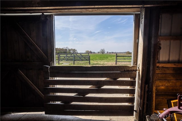 interior space with a rural view and wood walls