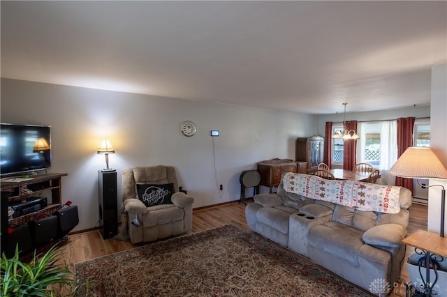 living room with hardwood / wood-style flooring and a notable chandelier