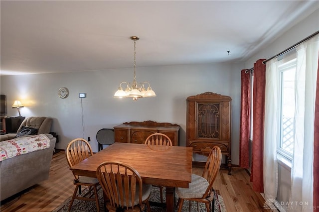 dining room with hardwood / wood-style flooring and a notable chandelier