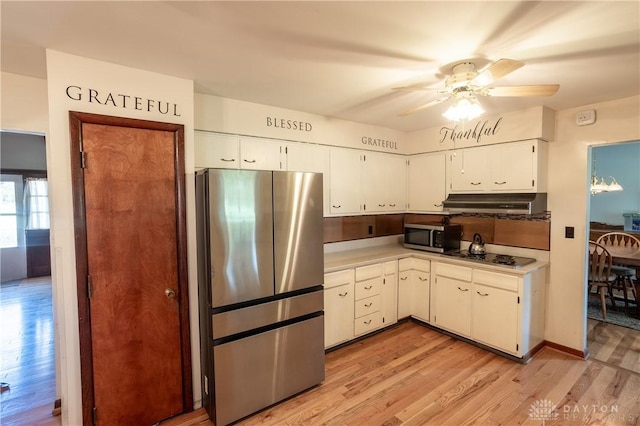 kitchen featuring white cabinets, ceiling fan, light wood-type flooring, and appliances with stainless steel finishes