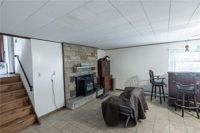 living room with a wood stove and baseboard heating