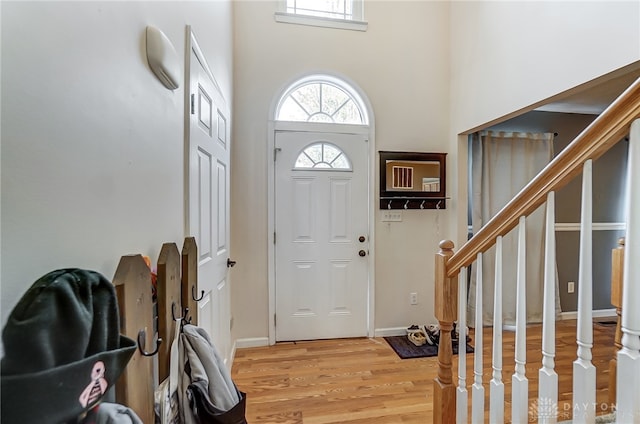 entryway featuring light hardwood / wood-style floors and a high ceiling