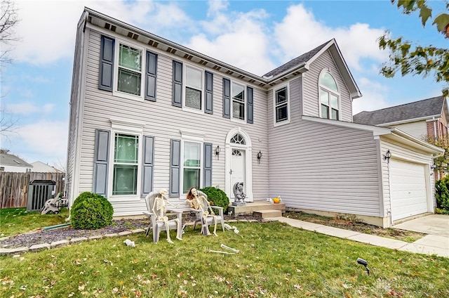 view of front of property featuring central AC unit, a front lawn, and a garage