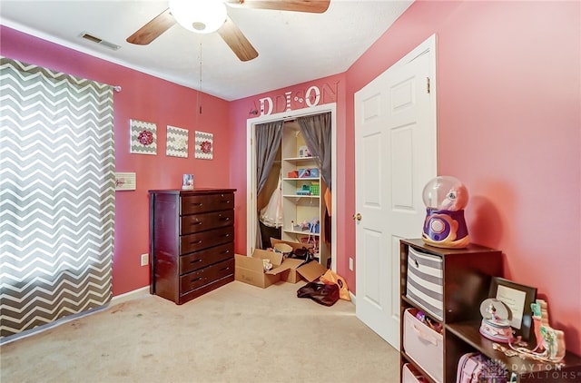 interior space with carpet flooring, a closet, and ceiling fan