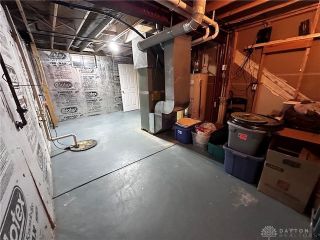 basement with gas water heater and heating unit