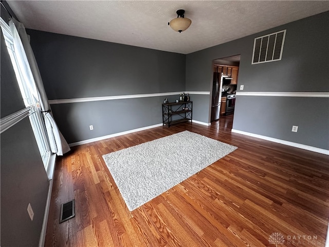 interior space featuring hardwood / wood-style floors, a healthy amount of sunlight, and a textured ceiling