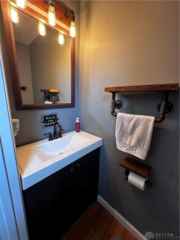 bathroom with hardwood / wood-style floors and vanity