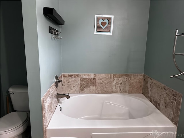 bathroom with toilet and a bath