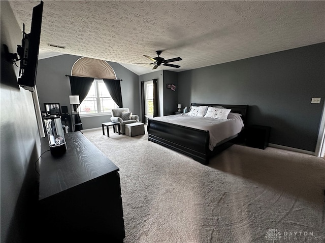 bedroom featuring ceiling fan, carpet floors, and a textured ceiling