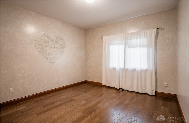 empty room with wood-type flooring