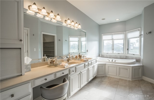 bathroom featuring vanity, tile patterned flooring, and a bathing tub